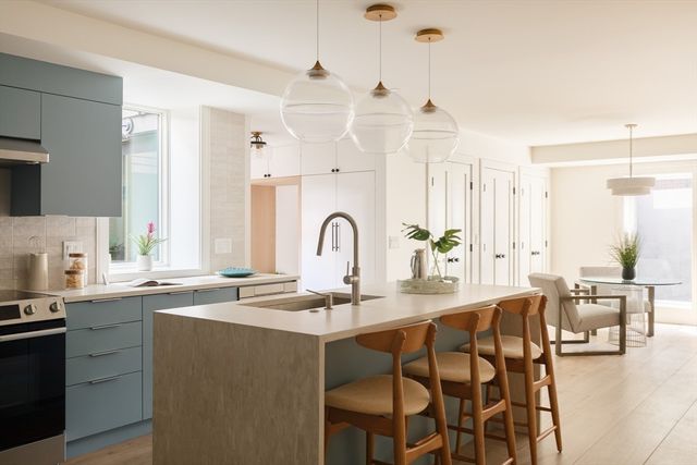 a kitchen with granite countertop a sink stainless steel appliances and cabinets
