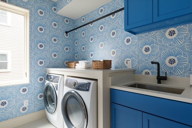 a utility room with sink dryer and washer