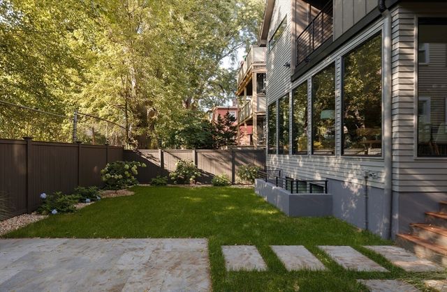 a view of a house with backyard and sitting area