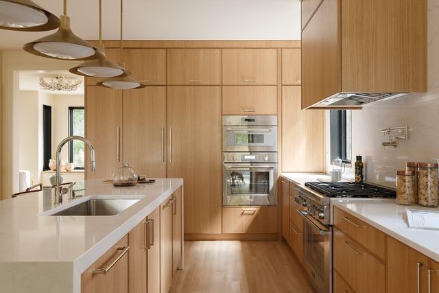 a kitchen with stainless steel appliances a sink stove and refrigerator