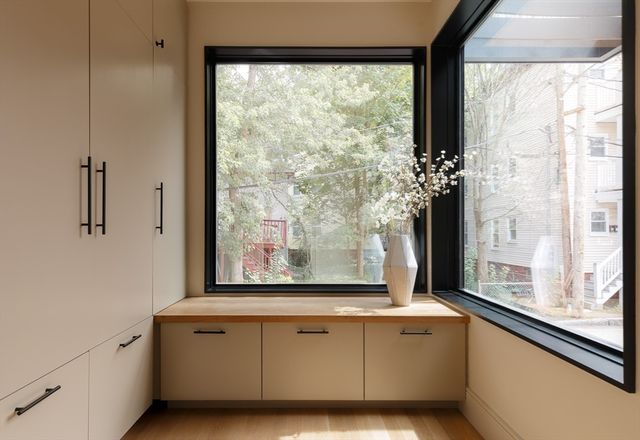a bathroom with a window sink and mirror