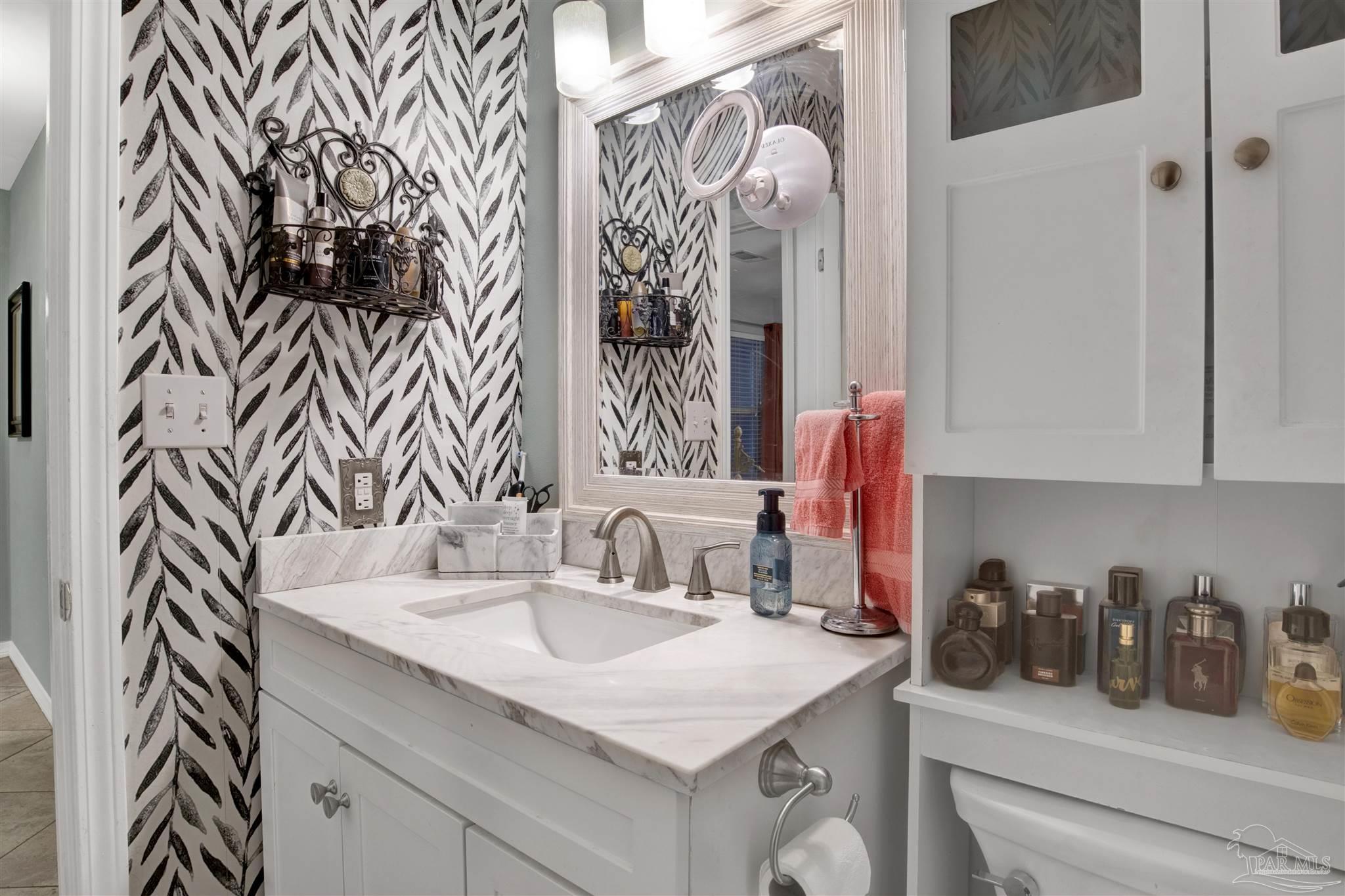 13351 Johnson Beach Road, Unit 203E Perdido Key, FL 32507 - Photo 23 of 55 a bathroom with a sink and a mirror