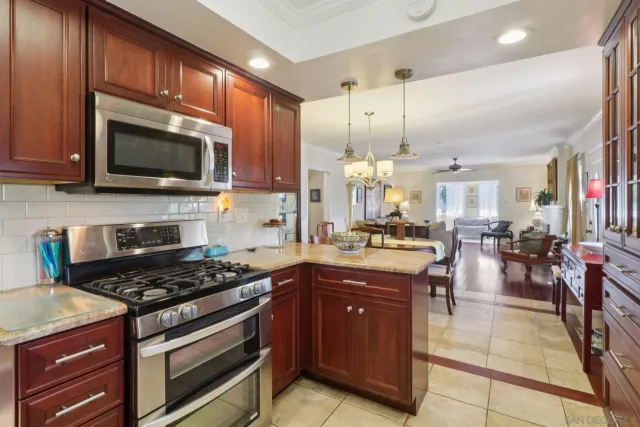 a kitchen with stainless steel appliances kitchen island granite countertop a stove and cabinets