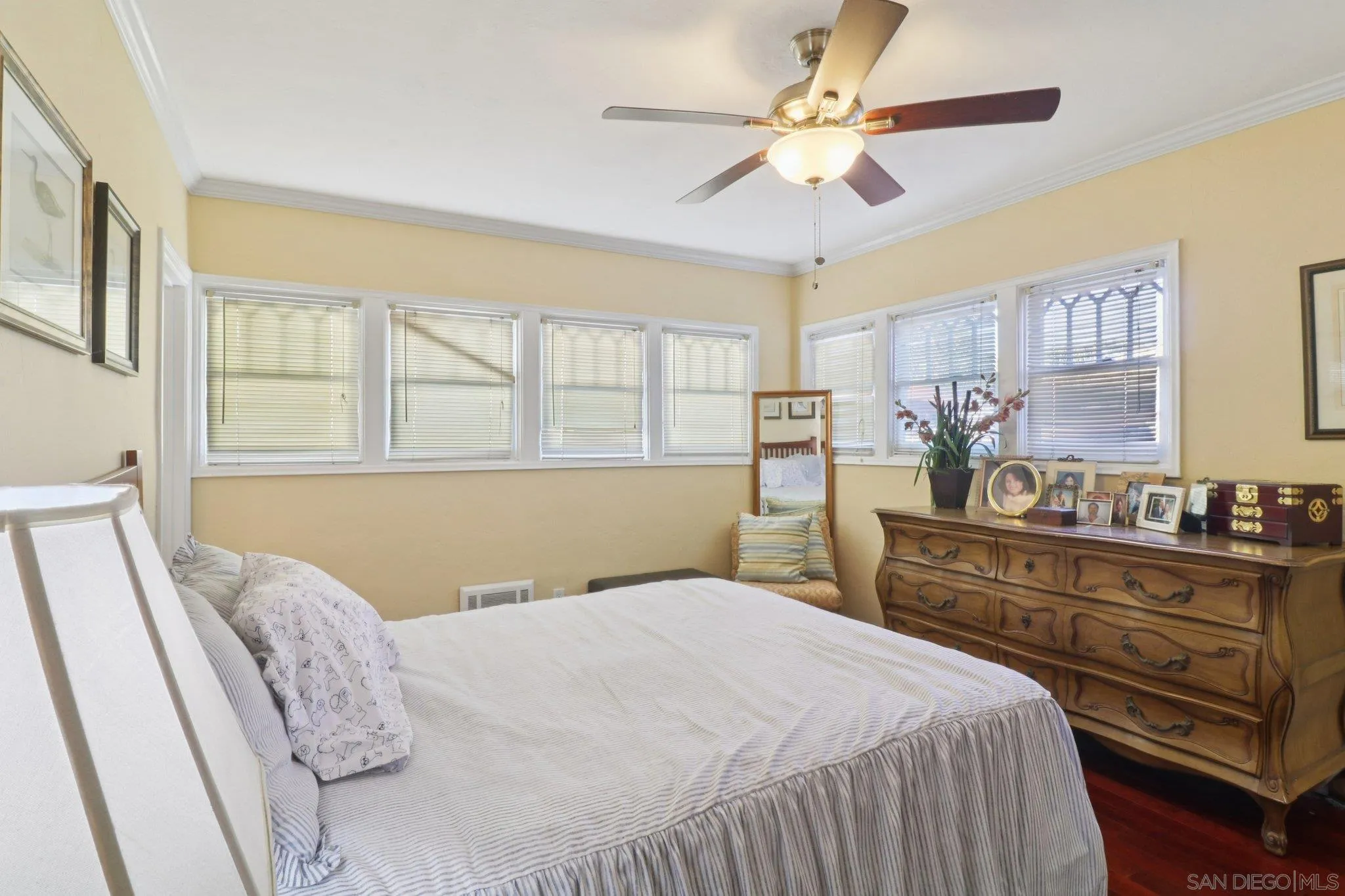3509-11 32nd Street San Diego, CA 92104 - Photo 17 of 51 a bedroom with a large bed and a chandelier