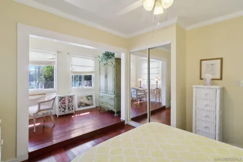 a bedroom with a bed and wooden floor