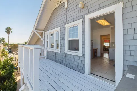 a view of a porch with wooden floor and a yard