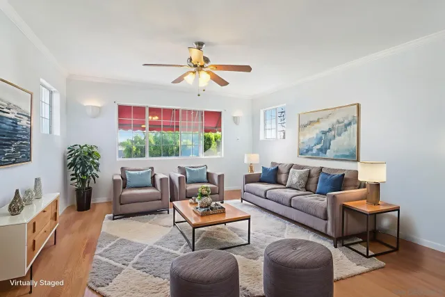 a living room with furniture kitchen view and a window