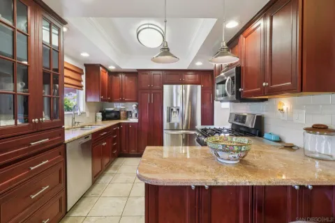 a kitchen with a table chairs and wooden cabinets