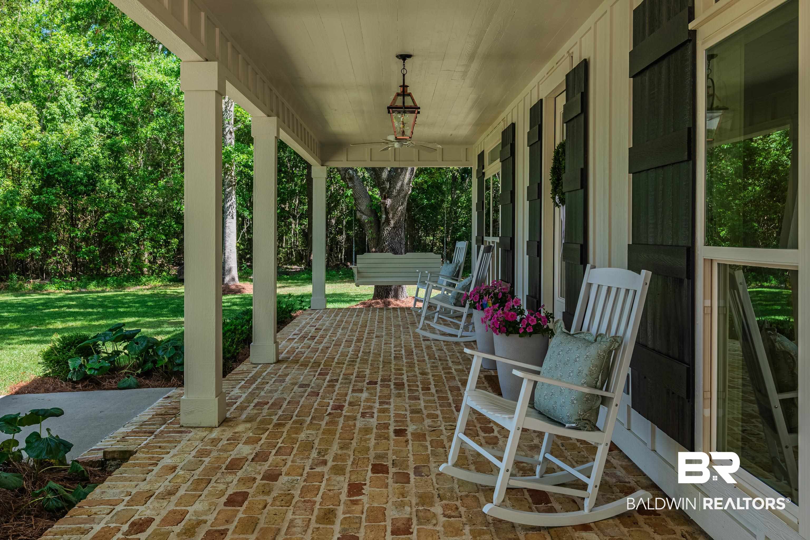 19121 Boothe Road Fairhope, AL 36532 - Photo 38 of 41 Covered porch featuring a lawn and ceiling fan