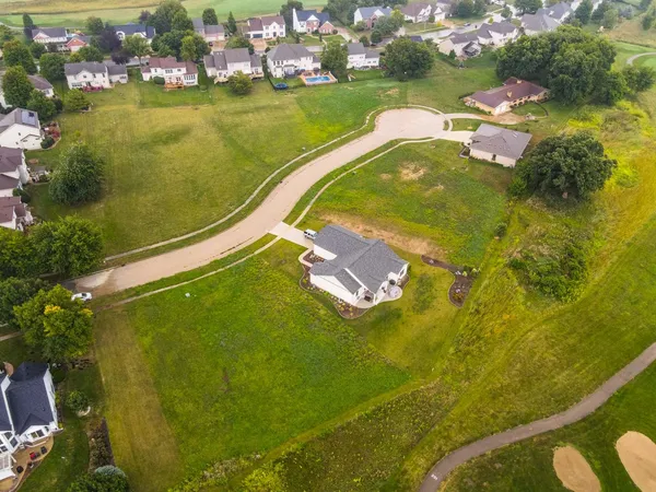 an aerial view of a residential houses with outdoor space and swimming pool