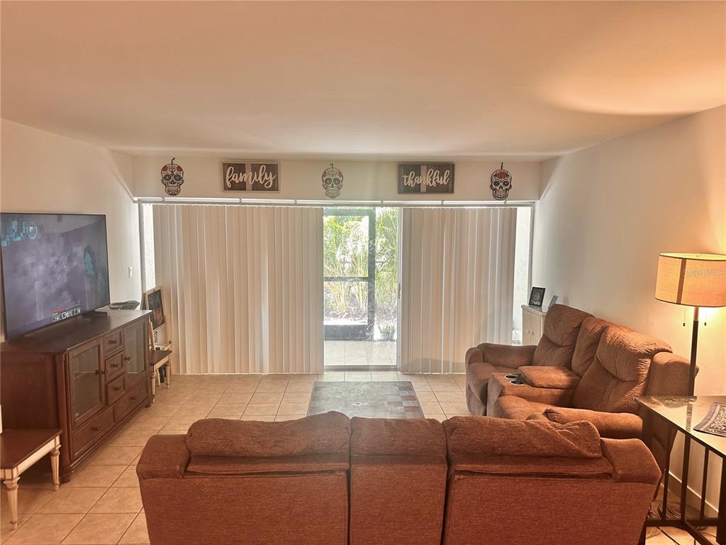 2938 Clark Road, Unit 102 Sarasota, FL 34231 - Photo 13 of 14 a living room with furniture and a window