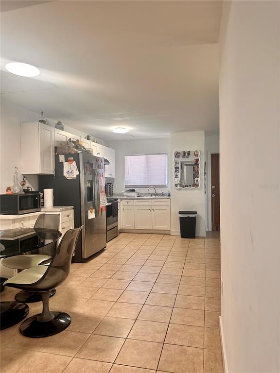 2938 Clark Road, Unit 102 Sarasota, FL 34231 - Photo 14 of 14 a kitchen with stainless steel appliances kitchen island granite countertop a refrigerator a stove and a sink with granite countertops