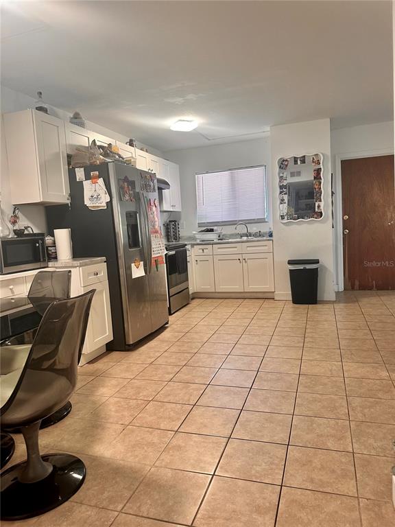 2938 Clark Road, Unit 102 Sarasota, FL 34231 - Photo 3 of 14 a room with a washing machine and chairs