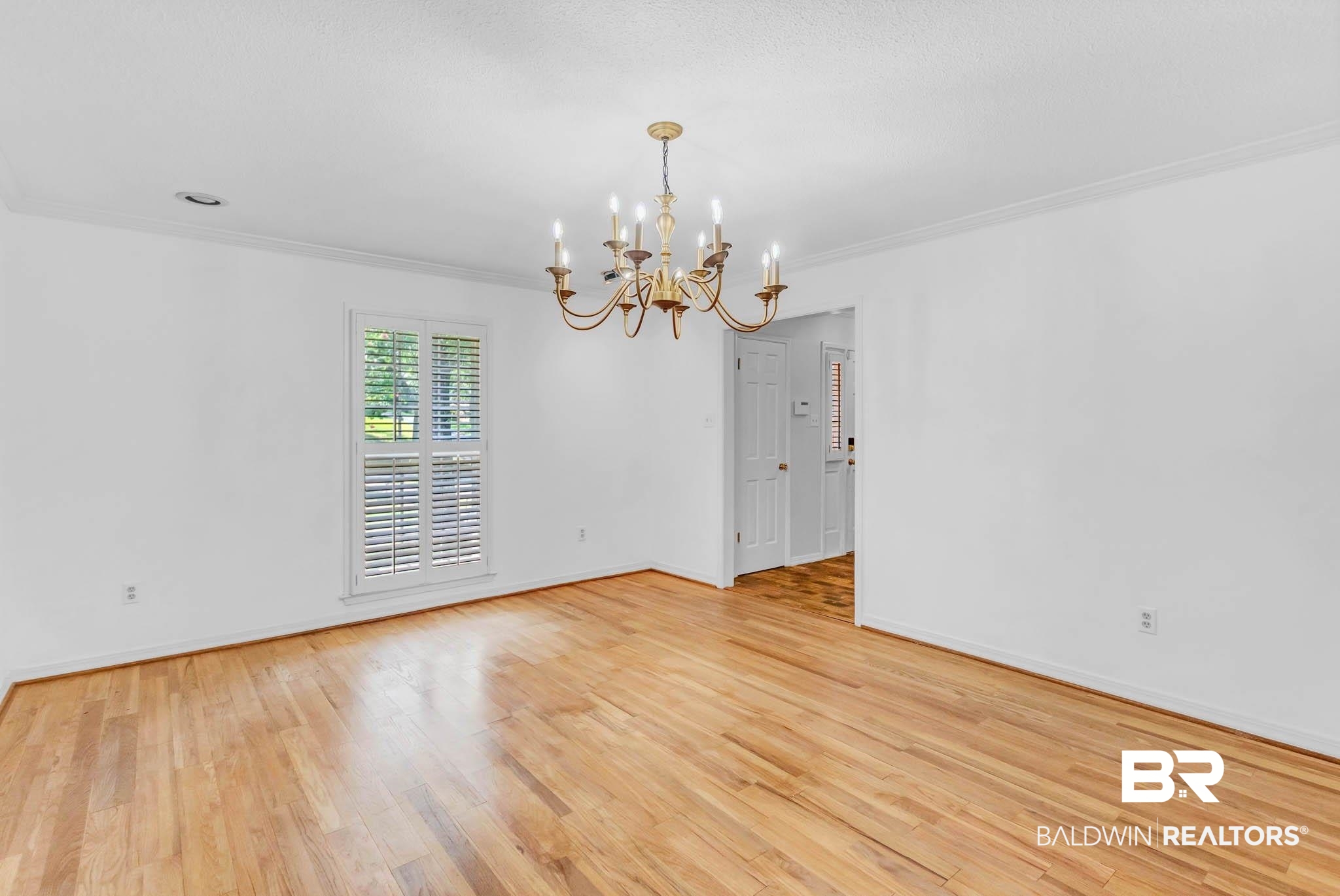 309 West Brandy Run Road Mobile, AL 36608 - Photo 30 of 100 Spare room featuring ornamental molding, a chandelier, and light wood finished floors