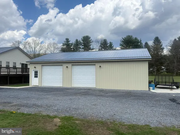 a view of a house with a yard and garage
