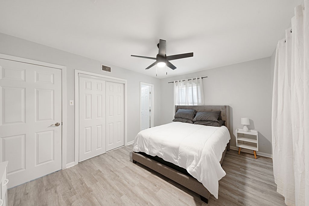 614 Gilpin Street Houston, TX 77034 - Photo 10 of 27 Discover the serene primary bedroom, complete with a convenient entrance to a private ensuite bathroom, offering a perfect retreat for relaxation.