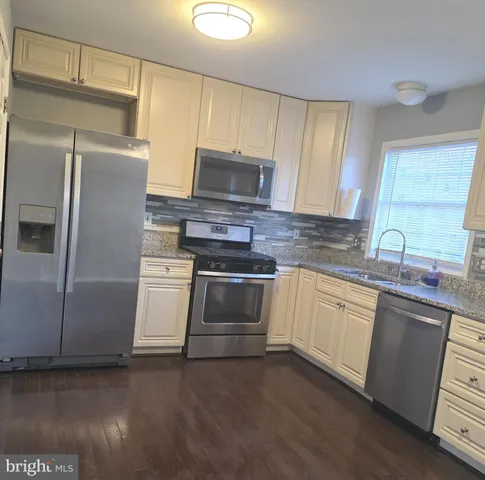 a white toilet sitting next to a white sink