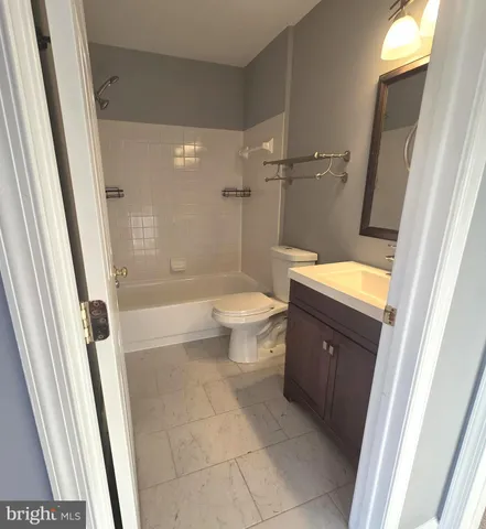 a view of room with a ceiling fan and window