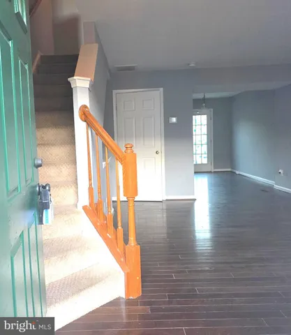 a view of a room with wooden floor and window