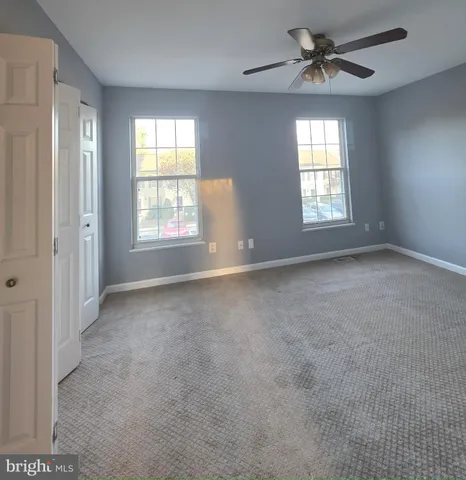 a view of an entryway with wooden floor and windows
