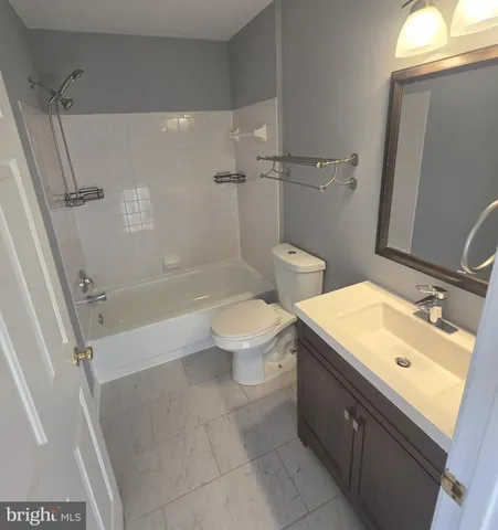 a bath tub sitting next to a white sink