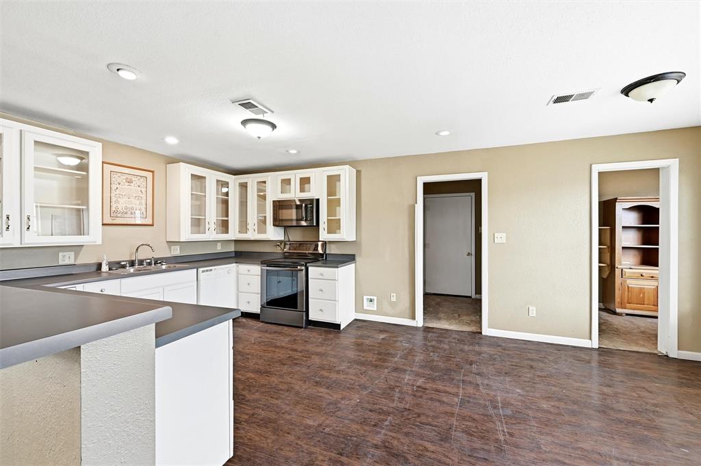 81937 Highway 289 Pottsboro, TX 75076 - Photo 12 of 33 a large kitchen with stainless steel appliances granite countertop a large counter top and a stove