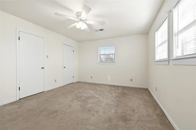 a bathroom with a toilet a sink and a window