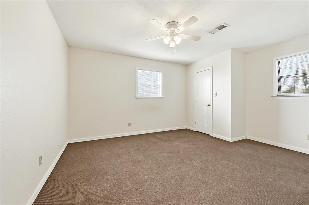 81937 Highway 289 Pottsboro, TX 75076 - Photo 19 of 33 an empty room with a chandelier fan and windows