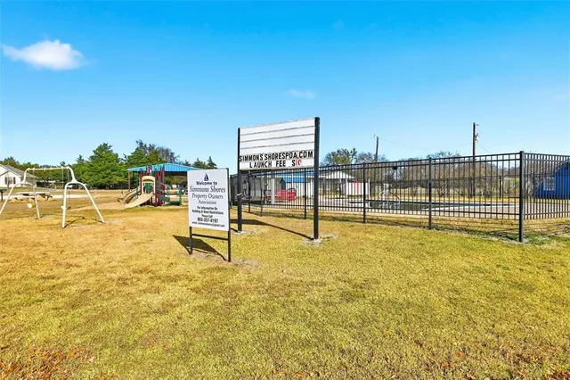 a view of a swimming pool with an outdoor seating and a yard