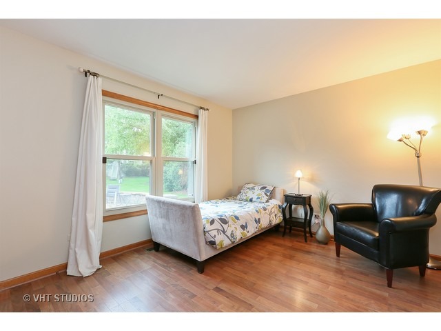 2481 Rio Grande Circle Naperville, IL 60565 - Photo 13 of 25 a bedroom with furniture and a wooden floor