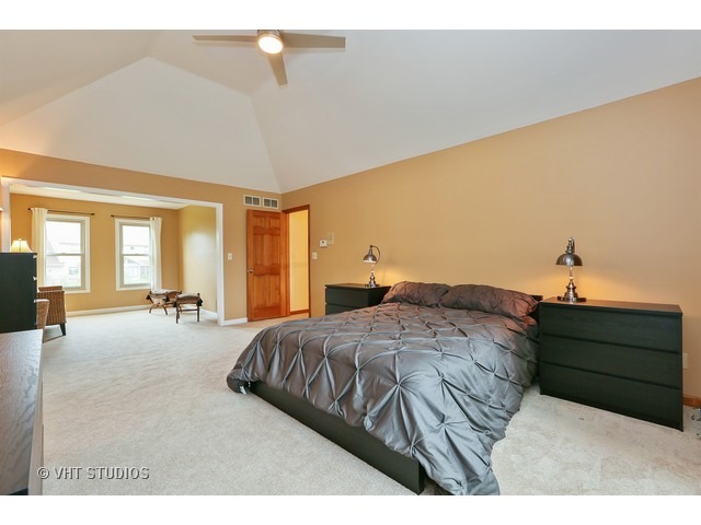 2481 Rio Grande Circle Naperville, IL 60565 - Photo 15 of 25 a spacious bedroom with a bed a dresser and large windows