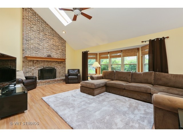 2481 Rio Grande Circle Naperville, IL 60565 - Photo 10 of 25 a living room with furniture flat screen tv and a fireplace