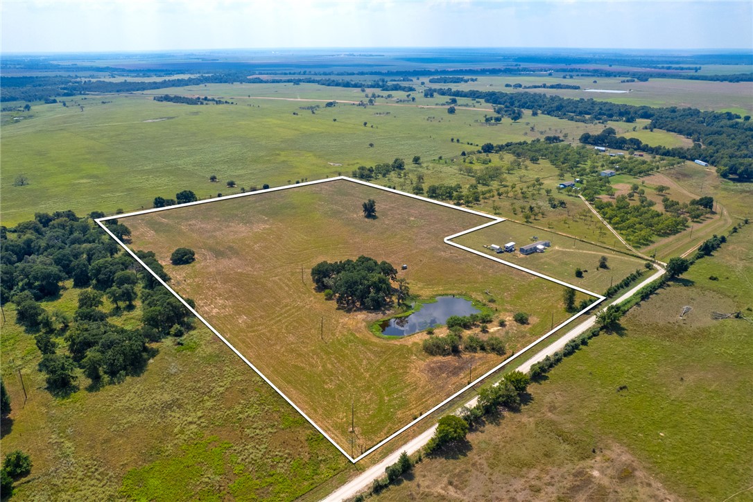 11733 Winstead Lane Calvert, TX 77837 - Photo 4 of 26 Aerial view of sparsely populated area with property boundaries highlighted and a large body of water