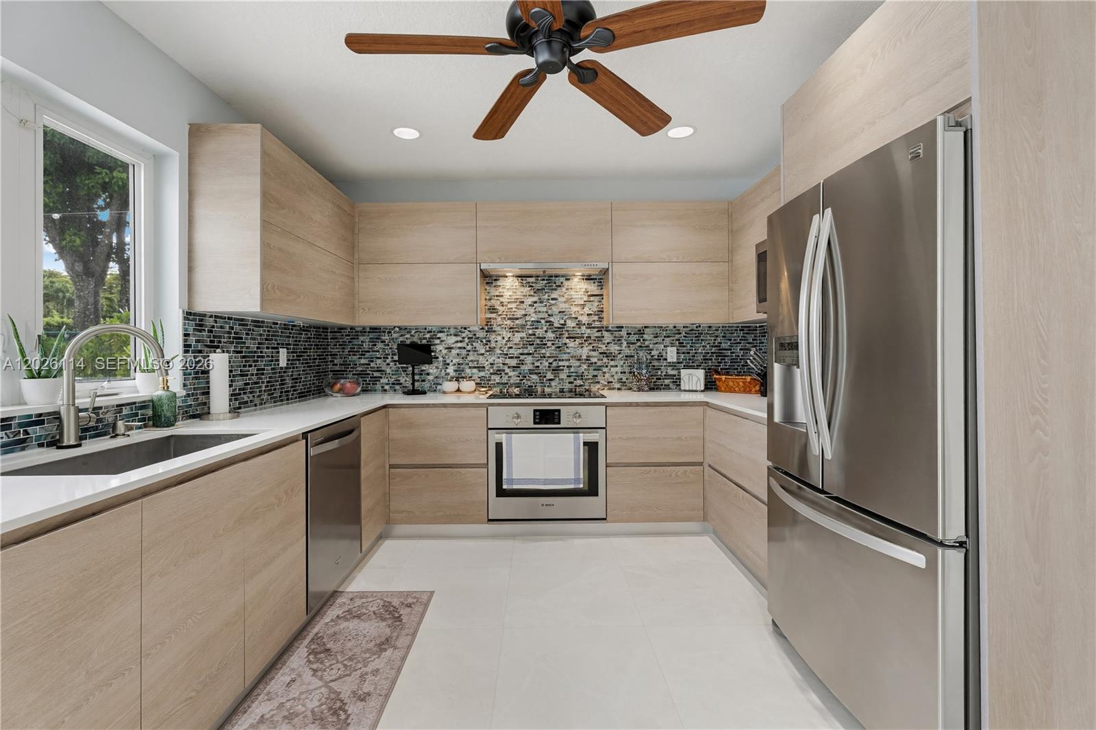 9641 Southwest 66th Street Miami, FL 33173 - Photo 22 of 57 a kitchen with a refrigerator and a sink