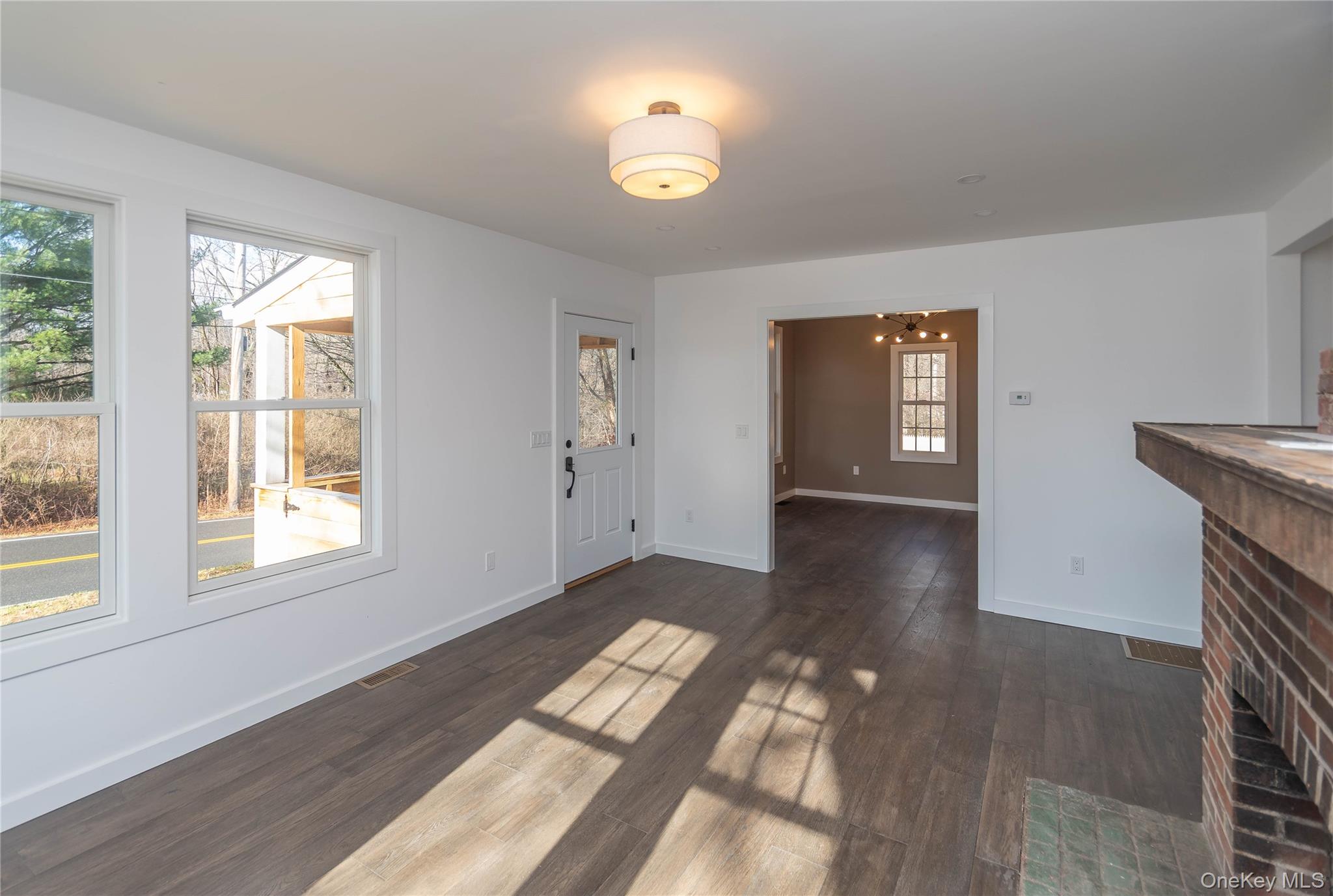 3 Anna Street Kerhonkson, NY 12446 - Photo 13 of 40 Unfurnished living room featuring dark wood floors and a chandelier