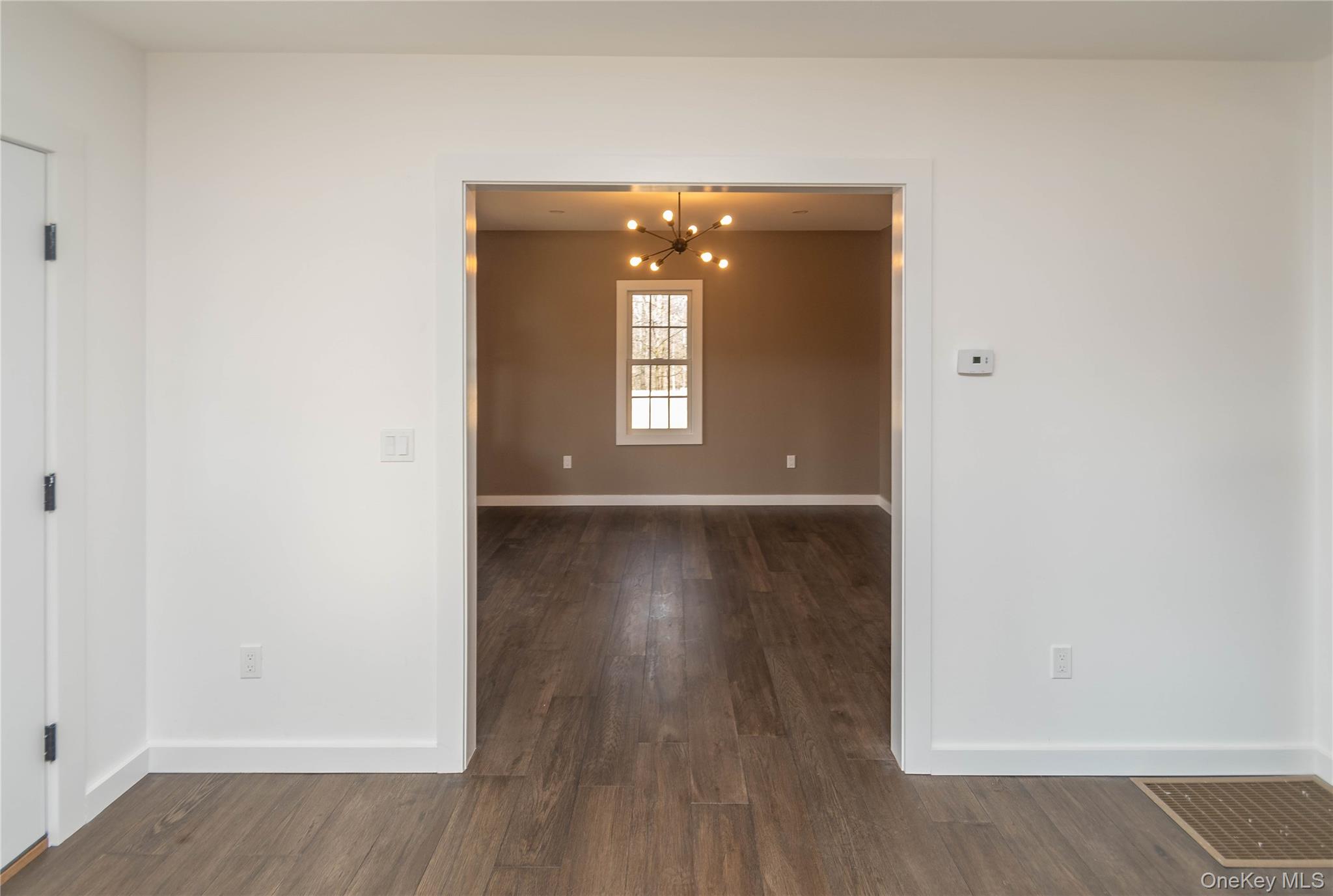 3 Anna Street Kerhonkson, NY 12446 - Photo 14 of 40 Spare room featuring a chandelier and dark wood floors