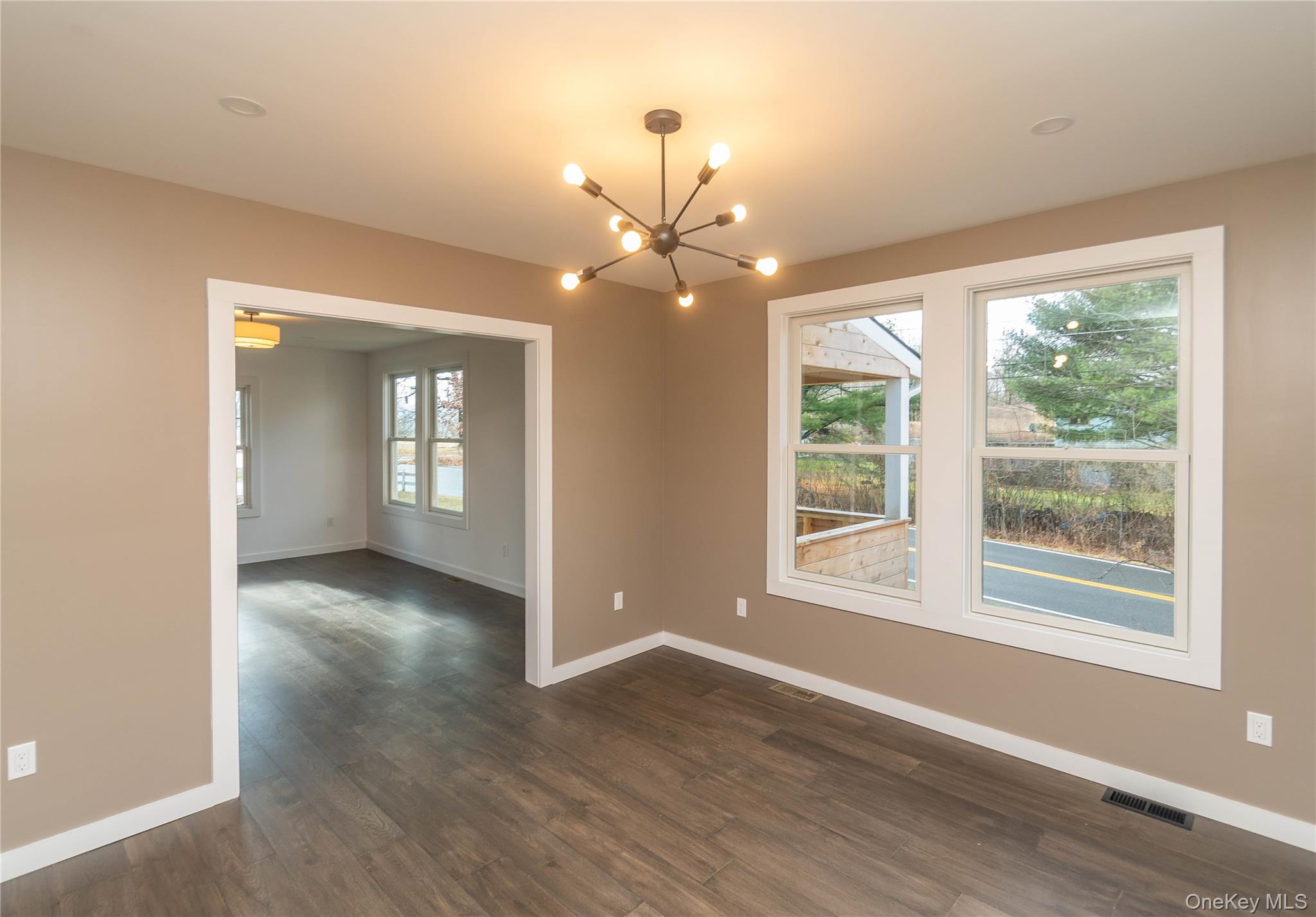 3 Anna Street Kerhonkson, NY 12446 - Photo 16 of 40 Empty room featuring a chandelier and dark wood floors
