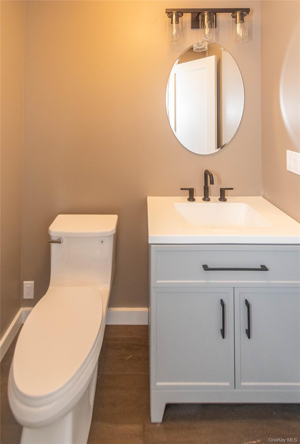 3 Anna Street Kerhonkson, NY 12446 - Photo 18 of 40 Half bathroom featuring vanity and dark wood floors