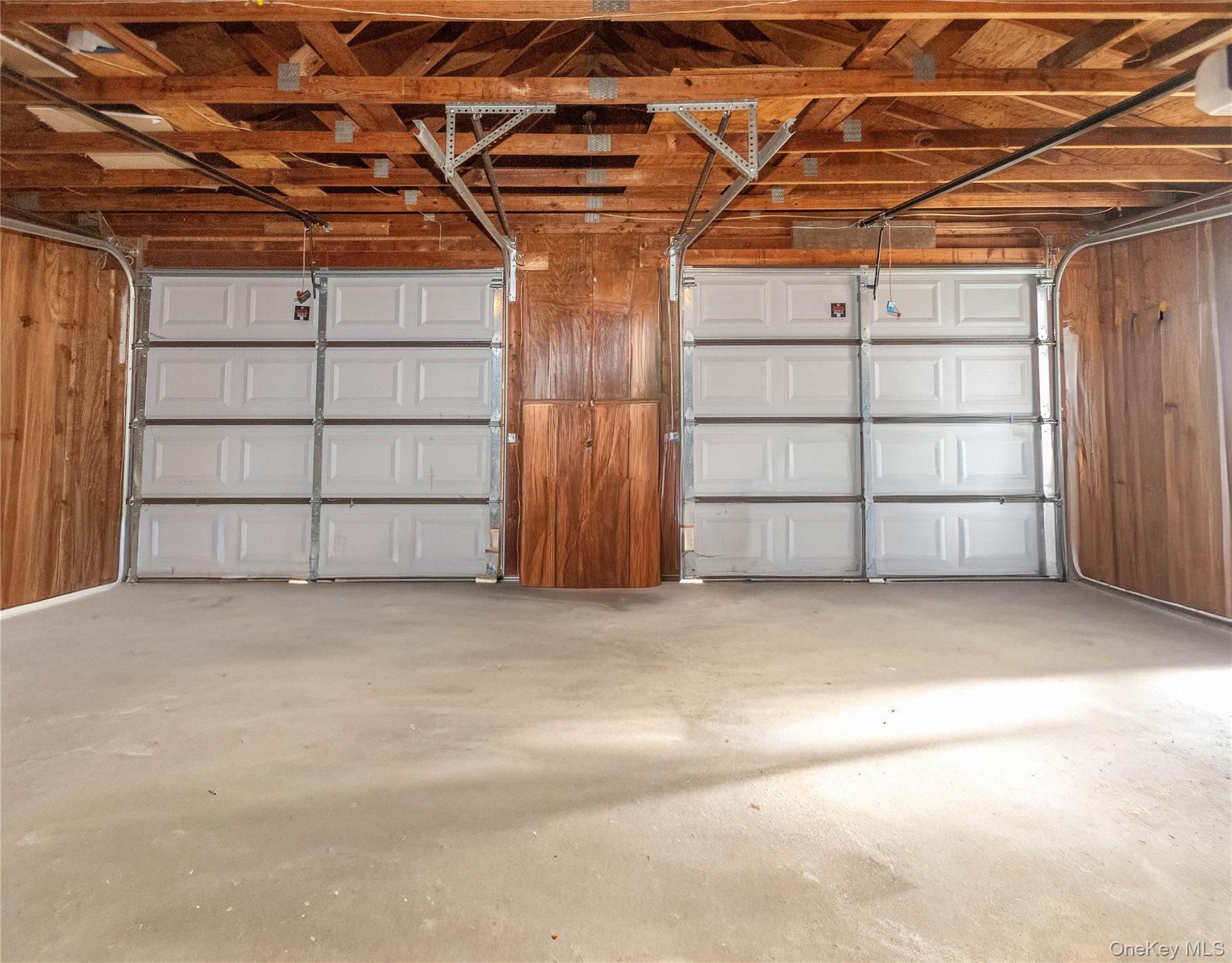 3 Anna Street Kerhonkson, NY 12446 - Photo 37 of 40 Garage with wood walls and a garage door opener