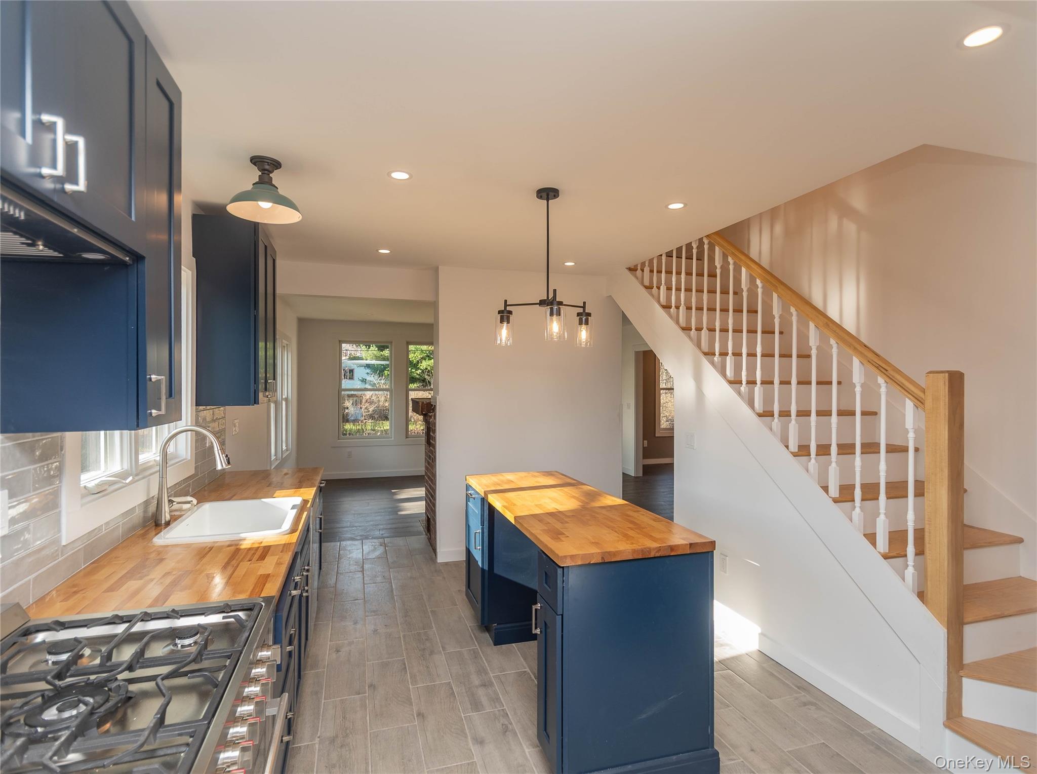 3 Anna Street Kerhonkson, NY 12446 - Photo 4 of 40 Kitchen featuring butcher block counters, blue cabinetry, recessed lighting, pendant lighting, and stainless steel gas range