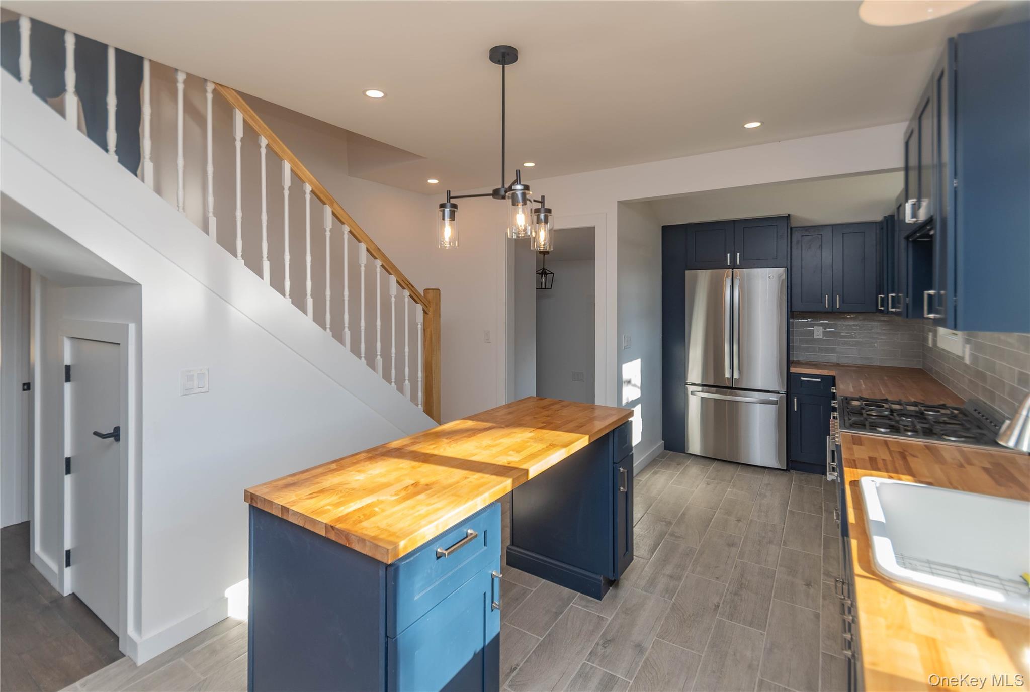 3 Anna Street Kerhonkson, NY 12446 - Photo 6 of 40 Kitchen featuring butcher block countertops, blue cabinets, pendant lighting, and recessed lighting