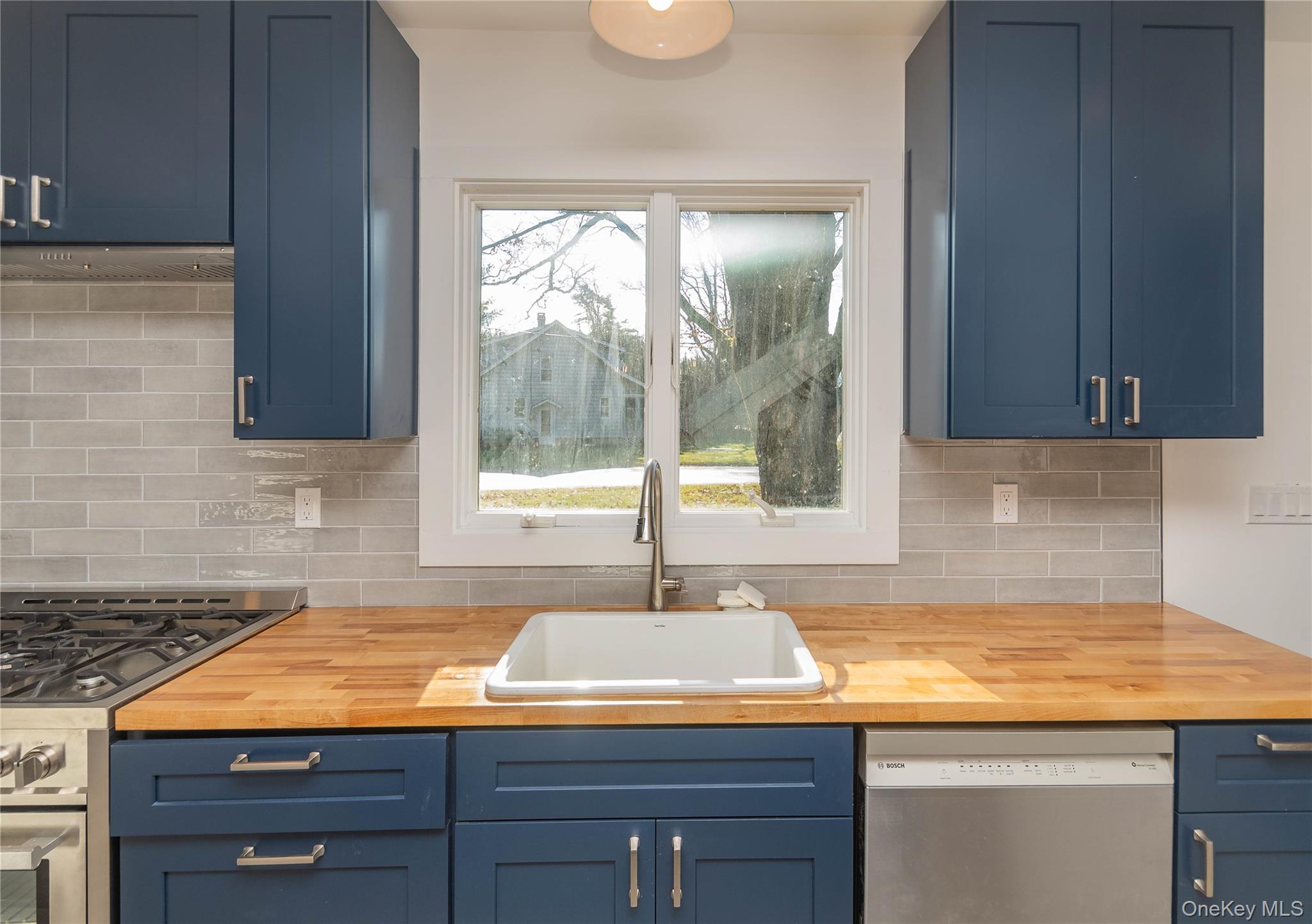 3 Anna Street Kerhonkson, NY 12446 - Photo 7 of 40 Kitchen with blue cabinets, stainless steel appliances, and wooden counters