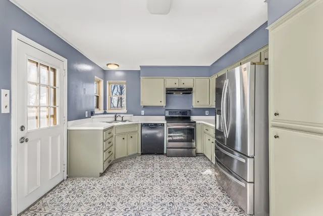 a kitchen with a refrigerator sink and stove