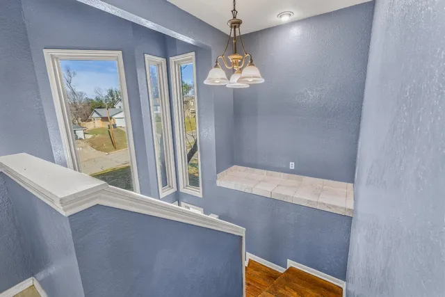 an empty room with a window and a ceiling fan