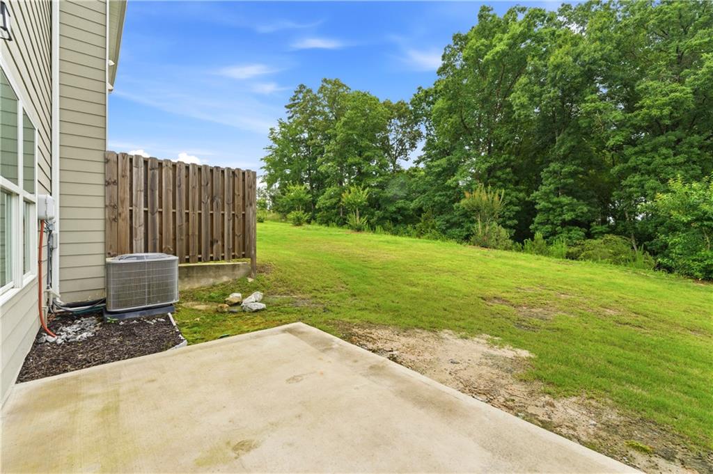 7492 Knoll Hollow Road Lithonia, GA 30058 - Photo 27 of 30 a view of a garden with wooden fence