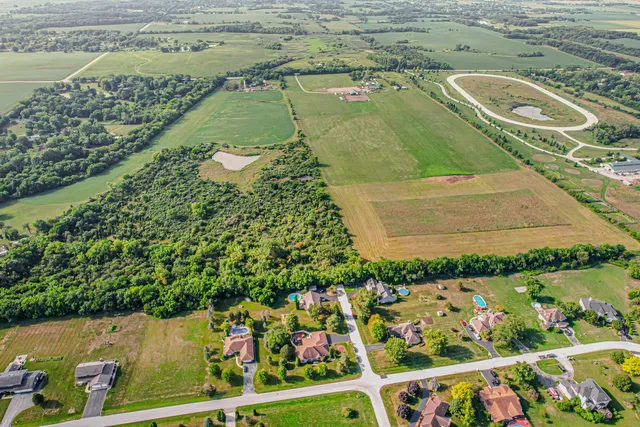 an aerial view of a residential houses with outdoor space