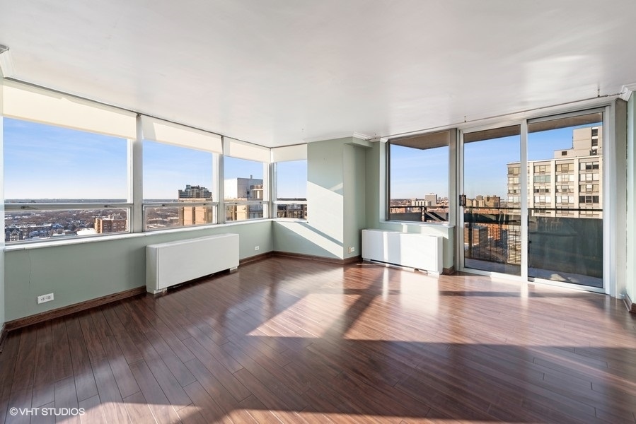 5701 North Sheridan Road, Unit 19B Chicago, IL 60660 - Photo 3 of 17 a kitchen with stainless steel appliances wooden floors and wooden cabinets