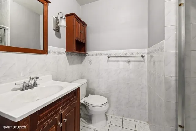 a bathroom with a sink a toilet and shower curtain