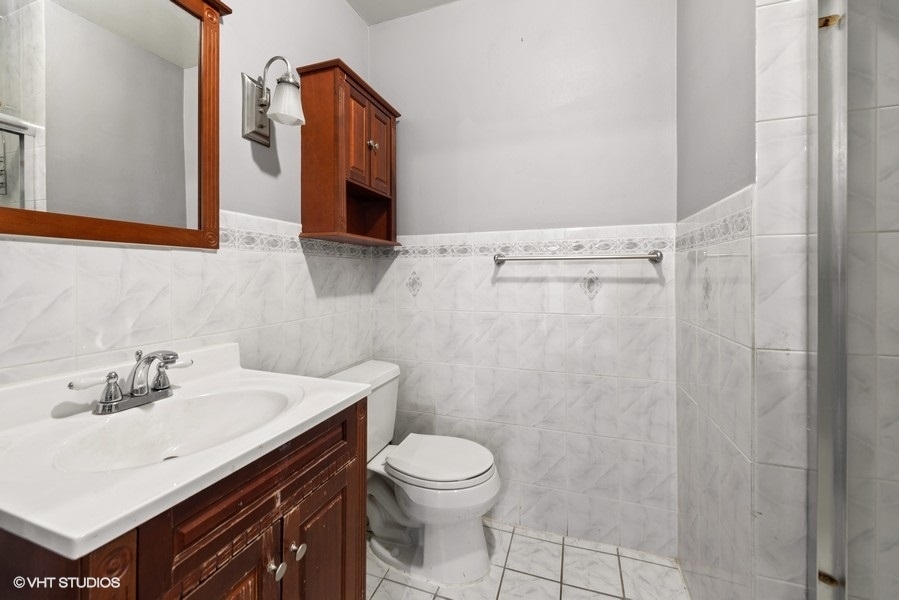 5701 North Sheridan Road, Unit 19B Chicago, IL 60660 - Photo 9 of 17 a bathroom with a sink a toilet and shower curtain