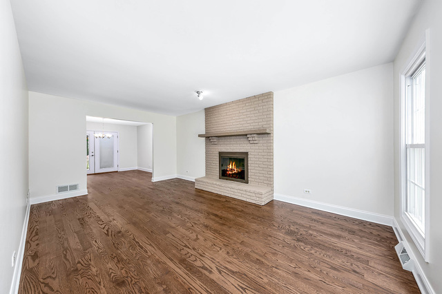 2010 Bilter Road Aurora, IL 60502 - Photo 12 of 47 a view of empty room with wooden floor and fireplace